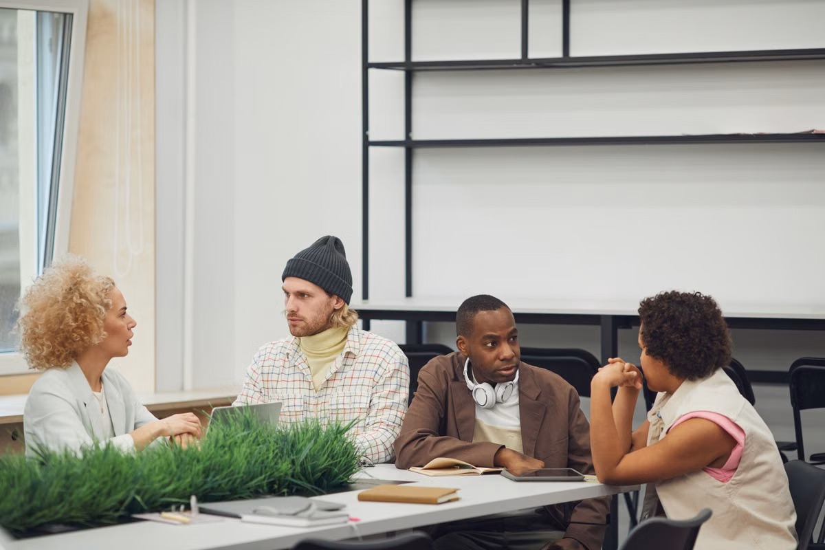 A diverse group of colleagues engaging in a collaborative meeting in a modern office setting.